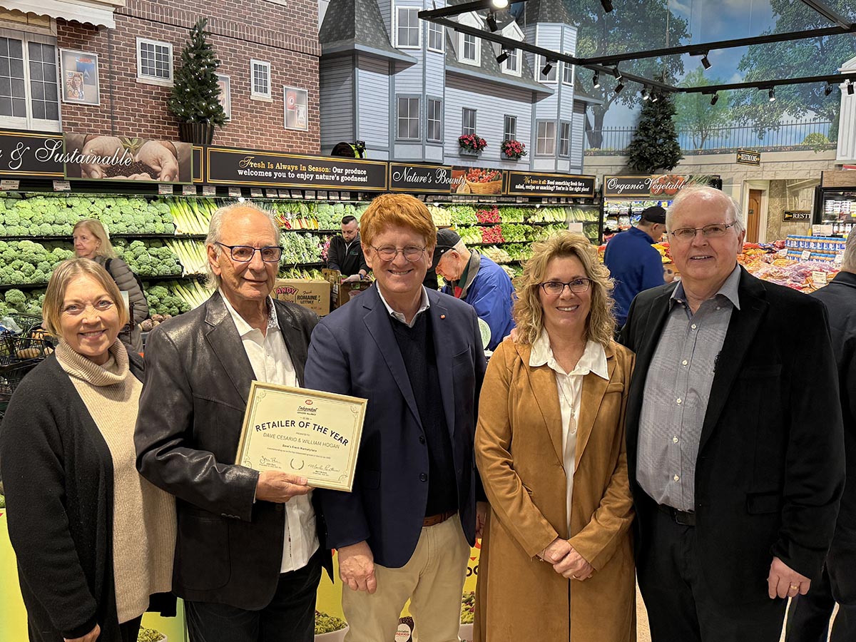 Dave Cesario and Bill Hogan of Dave's Fresh Marketplace accept the award as one of eight Best Retailers in the US from the Independent Grocers Alliance